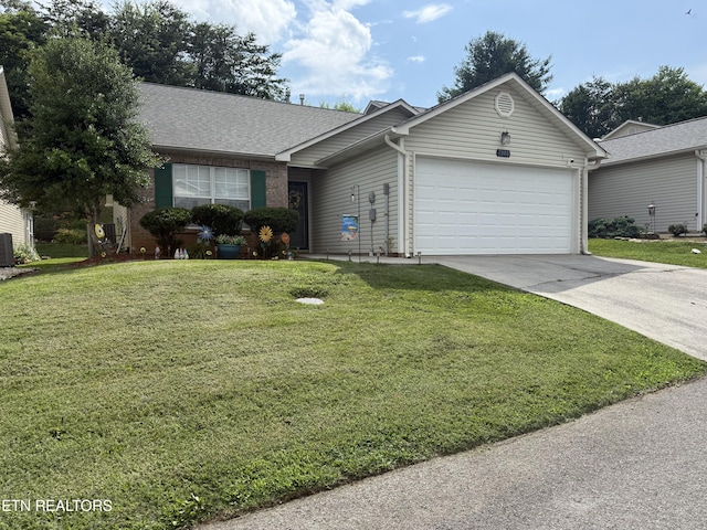 7808 Stone Garden Way, Powell, TN 37849 - ranch-style house with an attached garage, concrete driveway, a front yard, and a shingled roof