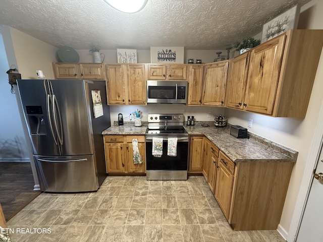 7808 Stone Garden Way, Powell, TN 37849 - kitchen featuring stainless steel appliances, stone countertops, brown cabinets, and a textured ceiling