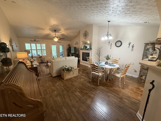 7808 Stone Garden Way, Powell, TN 37849 - living room featuring a textured ceiling, a glass covered fireplace, ceiling fan, dark wood-style flooring, and lofted ceiling