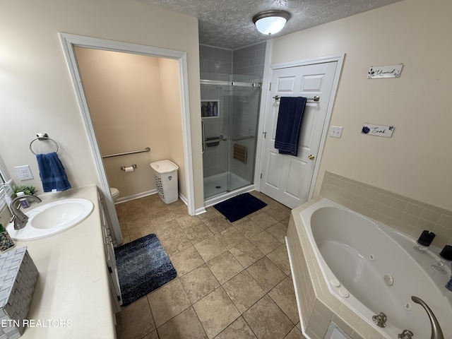 7808 Stone Garden Way, Powell, TN 37849 - full bathroom with a shower stall, a jetted tub, vanity, tile patterned floors, and a textured ceiling