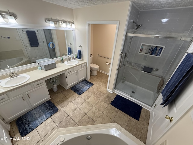 7808 Stone Garden Way, Powell, TN 37849 - bathroom with double vanity, a garden tub, a textured ceiling, a stall shower, and tile patterned floors