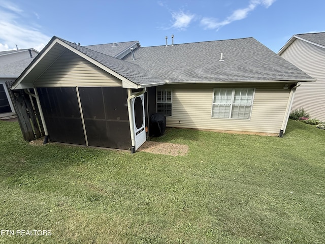 7808 Stone Garden Way, Powell, TN 37849 - back of property featuring a shingled roof, a sunroom, and a lawn