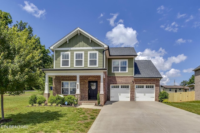 11944 Cordial Ln, Knoxville, TN 37932 - view of front facade with board and batten siding, brick siding, concrete driveway, an attached garage, and a shingled roof