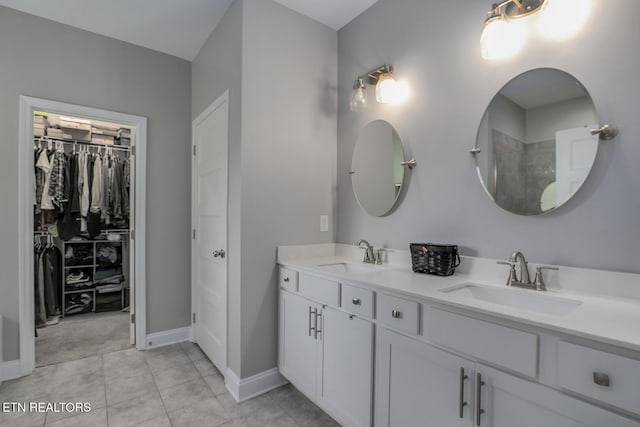 11944 Cordial Ln, Knoxville, TN 37932 - bathroom with double vanity, a walk in closet, tiled shower, and tile patterned flooring