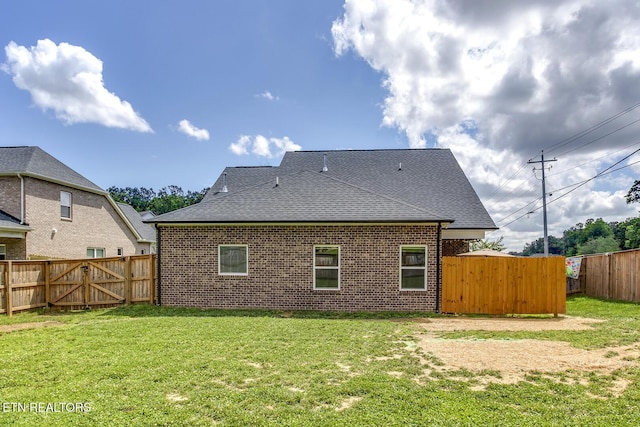 11944 Cordial Ln, Knoxville, TN 37932 - rear view of house with a fenced backyard, brick siding, roof with shingles, and a gate