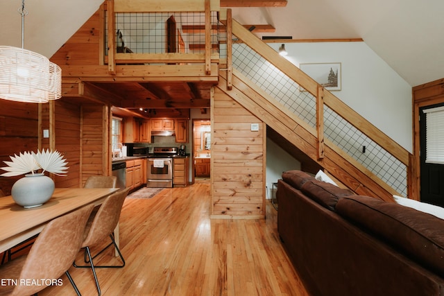 3653 Country Pines Way, Sevierville, TN 37876 - living area featuring wood walls, lofted ceiling, light wood-type flooring, and stairs