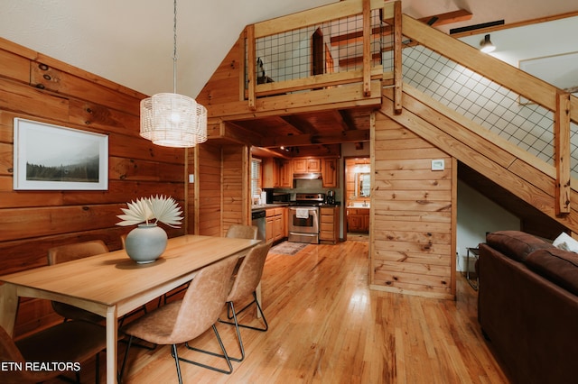 3653 Country Pines Way, Sevierville, TN 37876 - dining room featuring wood walls, light wood-style floors, and lofted ceiling