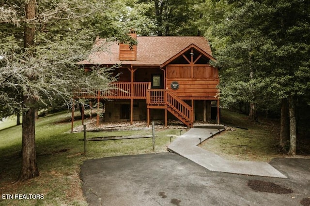 3653 Country Pines Way, Sevierville, TN 37876 - view of front of property with stairway, a wooden deck, a shingled roof, a front lawn, and a chimney