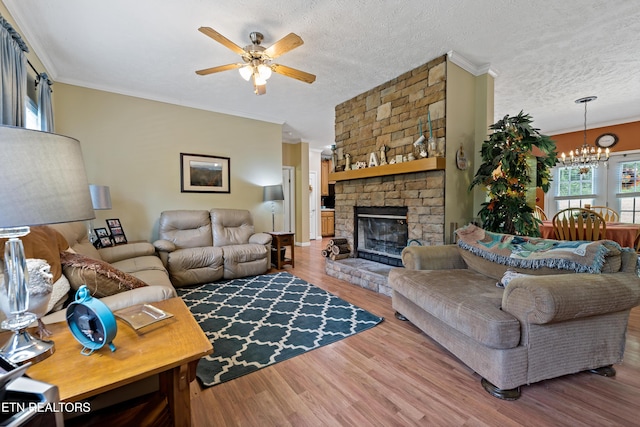 1914 Old Chilhowee Rd, Seymour, TN 37865 - living room with a ceiling fan, a chandelier, ornamental molding, wood finished floors, and a large fireplace