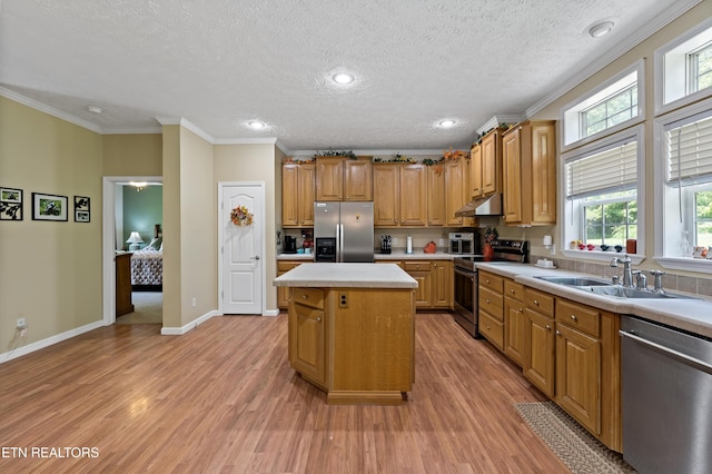 1914 Old Chilhowee Rd, Seymour, TN 37865 - kitchen featuring stainless steel appliances, under cabinet range hood, light countertops, light wood-style flooring, and a center island