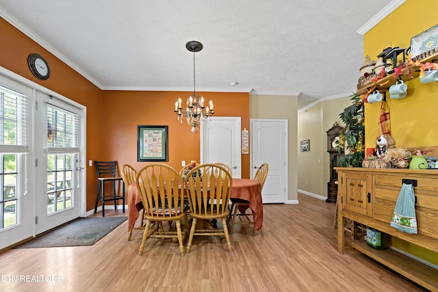 1914 Old Chilhowee Rd, Seymour, TN 37865 - dining room with a chandelier, light wood-style flooring, crown molding, and a textured ceiling