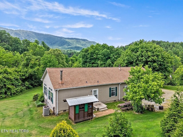 1914 Old Chilhowee Rd, Seymour, TN 37865 - rear view of property with a storage shed, a lawn, a wooded view, crawl space, and roof with shingles