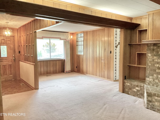 3505 Hackworth Rd, Knoxville, TN 37931 - unfurnished living room featuring wooden walls, carpet flooring, and a chandelier