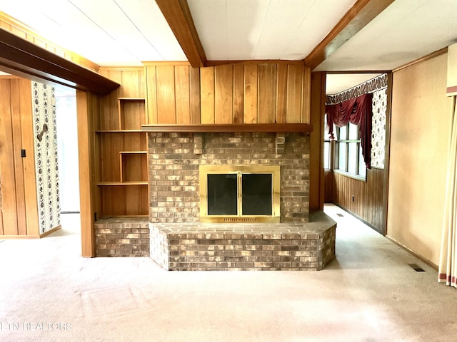 3505 Hackworth Rd, Knoxville, TN 37931 - unfurnished living room featuring wooden walls, carpet flooring, a fireplace, and beam ceiling