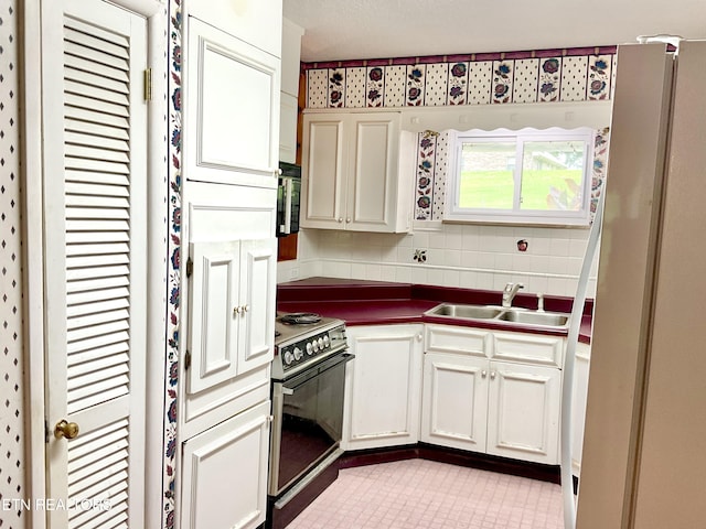 3505 Hackworth Rd, Knoxville, TN 37931 - kitchen with electric stove, dark countertops, light tile patterned floors, and tasteful backsplash