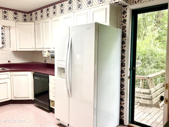 3505 Hackworth Rd, Knoxville, TN 37931 - kitchen with white fridge with ice dispenser, black dishwasher, dark countertops, wallpapered walls, and white cabinets