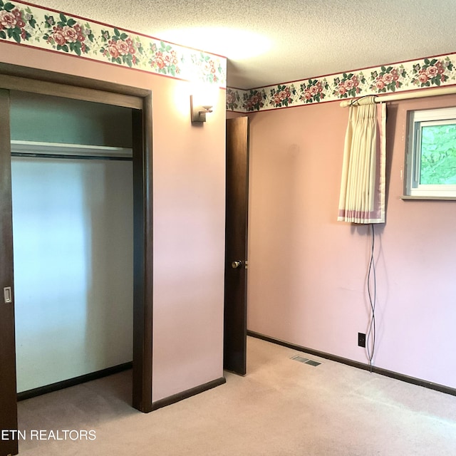 3505 Hackworth Rd, Knoxville, TN 37931 - unfurnished bedroom featuring carpet floors, a textured ceiling, and a closet