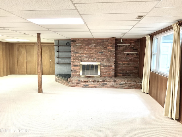 3505 Hackworth Rd, Knoxville, TN 37931 - basement featuring wood walls, a brick fireplace, a paneled ceiling, and carpet floors
