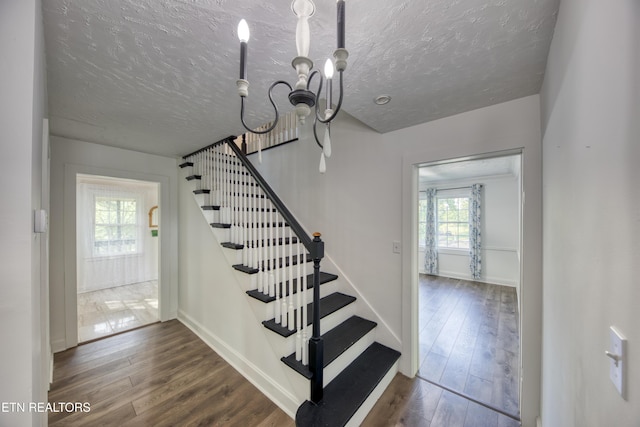 313 Edgewood Cir, Clinton, TN 37716 - stairway featuring a chandelier, wood finished floors, and a textured ceiling