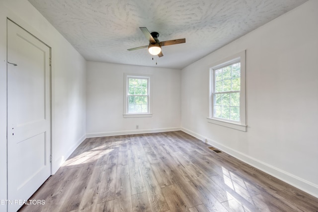 313 Edgewood Cir, Clinton, TN 37716 - spare room with healthy amount of natural light, wood finished floors, ceiling fan, and a textured ceiling