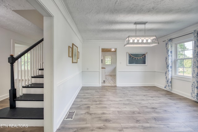 313 Edgewood Cir, Clinton, TN 37716 - unfurnished dining area featuring ornamental molding, a textured ceiling, wood finished floors, and stairs