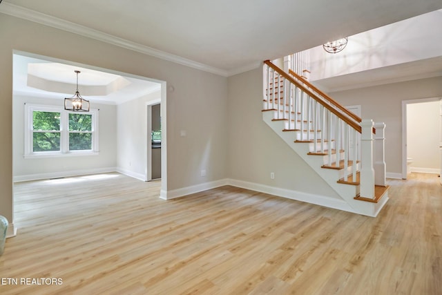 110 Lakecrest Ln, Oak Ridge, TN 37830 - unfurnished living room with a chandelier, wood finished floors, stairway, ornamental molding, and a tray ceiling