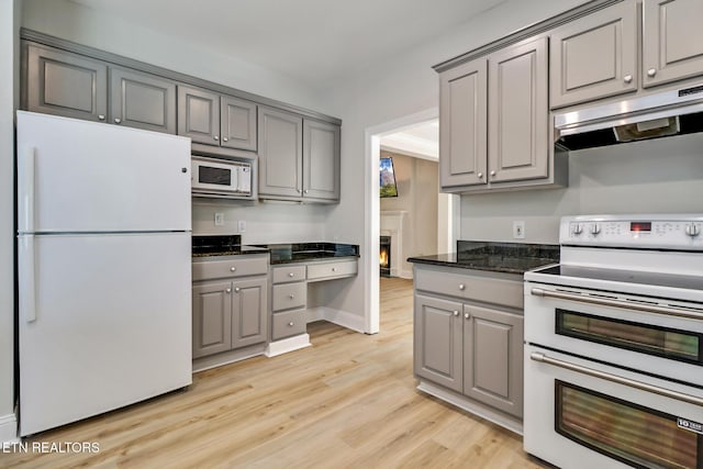 110 Lakecrest Ln, Oak Ridge, TN 37830 - kitchen with white appliances, gray cabinets, under cabinet range hood, and light wood-style flooring