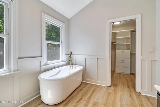 110 Lakecrest Ln, Oak Ridge, TN 37830 - full bathroom with a freestanding tub, wood finished floors, wainscoting, lofted ceiling, and a decorative wall