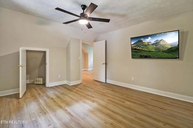 110 Lakecrest Ln, Oak Ridge, TN 37830 - unfurnished bedroom featuring light wood-type flooring, vaulted ceiling, a textured ceiling, ceiling fan, and radiator