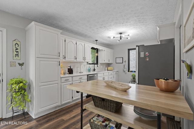 7217 Palermo Rd, Knoxville, TN 37918 - kitchen with stainless steel appliances, light countertops, dark wood-style floors, white cabinets, and a textured ceiling