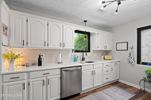 7217 Palermo Rd, Knoxville, TN 37918 - kitchen with stainless steel dishwasher, backsplash, dark wood finished floors, white cabinetry, and a textured ceiling