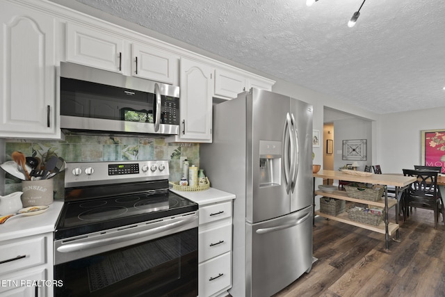 7217 Palermo Rd, Knoxville, TN 37918 - kitchen with stainless steel appliances, light countertops, dark wood-style flooring, white cabinetry, and a textured ceiling