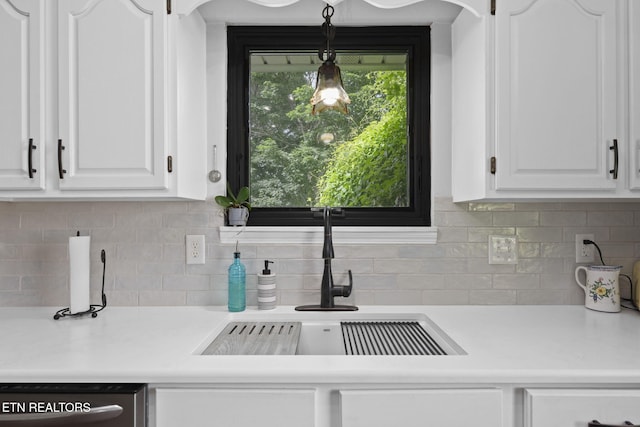 7217 Palermo Rd, Knoxville, TN 37918 - kitchen with dishwasher, white cabinets, light countertops, decorative backsplash, and hanging light fixtures