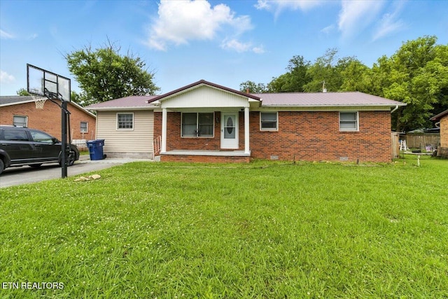 409 Meadow Ln, Middlesboro, KY 40965 - ranch-style home featuring a front yard, brick siding, and a metal roof