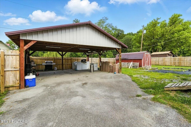 409 Meadow Ln, Middlesboro, KY 40965 - view of parking / parking lot with a detached carport, driveway, and a storage shed