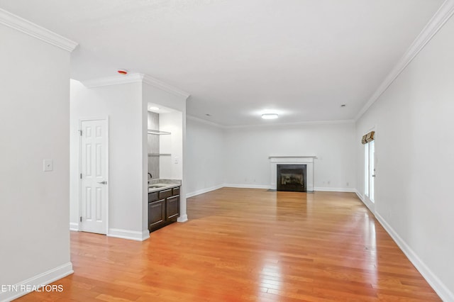 933 Gothic Manor Way, Knoxville, TN 37923 - unfurnished living room with light wood-style floors, ornamental molding, and a fireplace with flush hearth