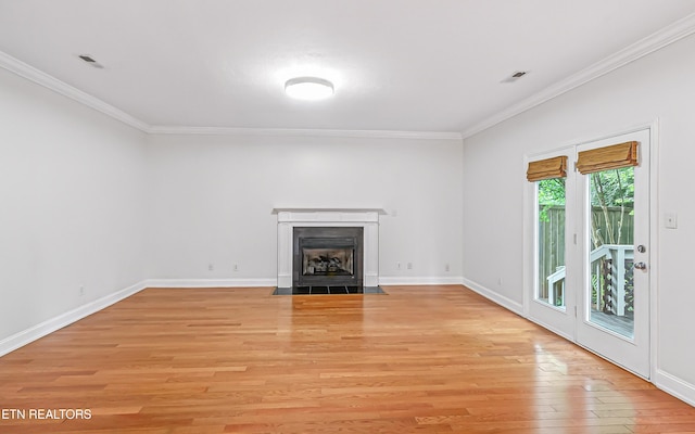 933 Gothic Manor Way, Knoxville, TN 37923 - unfurnished living room featuring crown molding, light wood-type flooring, and a fireplace with flush hearth