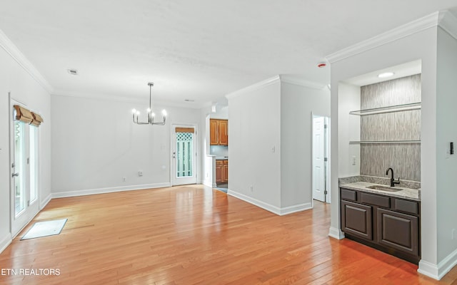933 Gothic Manor Way, Knoxville, TN 37923 - unfurnished living room with a chandelier, light wood-style floors, and crown molding