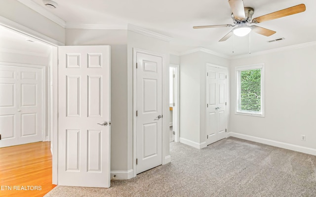 933 Gothic Manor Way, Knoxville, TN 37923 - unfurnished bedroom with light colored carpet, crown molding, ceiling fan, and a closet