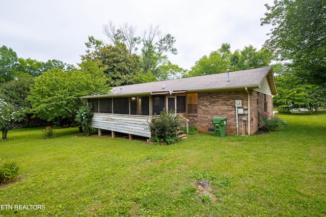 1705 Bobwhite Dr, Maryville, TN 37803 - back of house with a sunroom, a lawn, brick siding, and a shingled roof