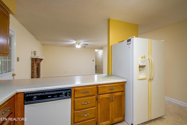 1705 Bobwhite Dr, Maryville, TN 37803 - kitchen with white appliances, a ceiling fan, a peninsula, brown cabinets, and a textured ceiling