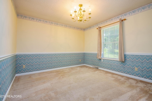 1705 Bobwhite Dr, Maryville, TN 37803 - spare room featuring wainscoting, a chandelier, wallpapered walls, carpet, and a textured ceiling
