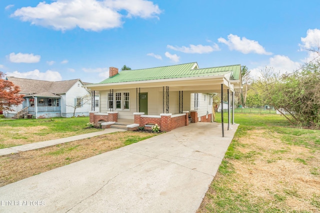 406 S Indiana Ave, Lafollette, TN 37766 - view of front of property with covered porch, concrete driveway, a chimney, a front lawn, and a carport