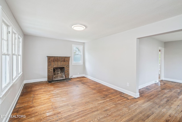 406 S Indiana Ave, Lafollette, TN 37766 - unfurnished living room with wood finished floors and a fireplace