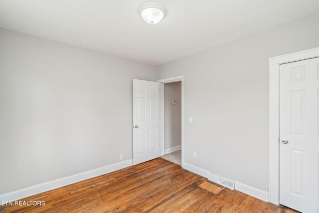 406 S Indiana Ave, Lafollette, TN 37766 - unfurnished bedroom with wood finished floors and baseboards