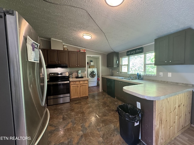 167 Marina Ln, Lafollette, TN 37766 - kitchen with appliances with stainless steel finishes, under cabinet range hood, light countertops, washer / dryer, and a textured ceiling