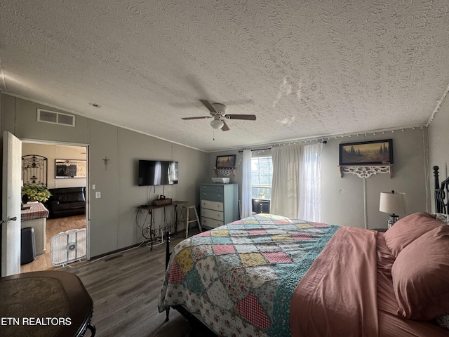 167 Marina Ln, Lafollette, TN 37766 - bedroom featuring wood finished floors, vaulted ceiling, a textured ceiling, and a ceiling fan
