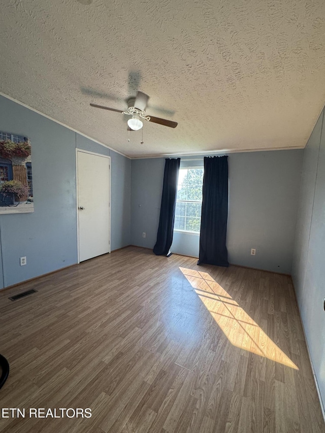167 Marina Ln, Lafollette, TN 37766 - empty room with wood finished floors, a ceiling fan, and a textured ceiling