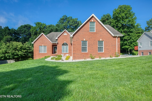 2150 Hirst Cir, Lenoir City, TN 37771 - view of front facade with brick siding and a front yard
