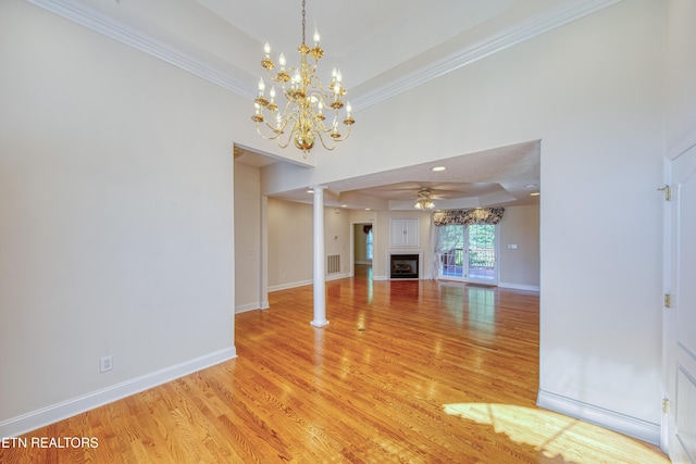 2150 Hirst Cir, Lenoir City, TN 37771 - unfurnished living room with a raised ceiling, a fireplace, light wood finished floors, ornamental molding, and a ceiling fan